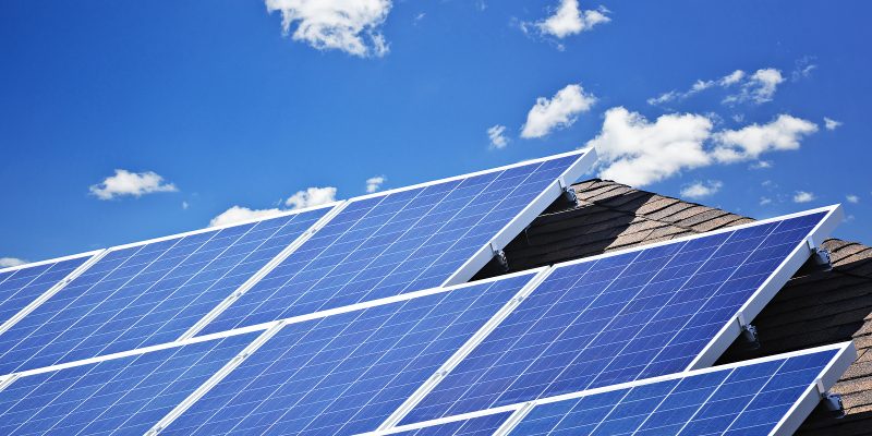 Array of alternative energy photovoltaic solar panels on roof